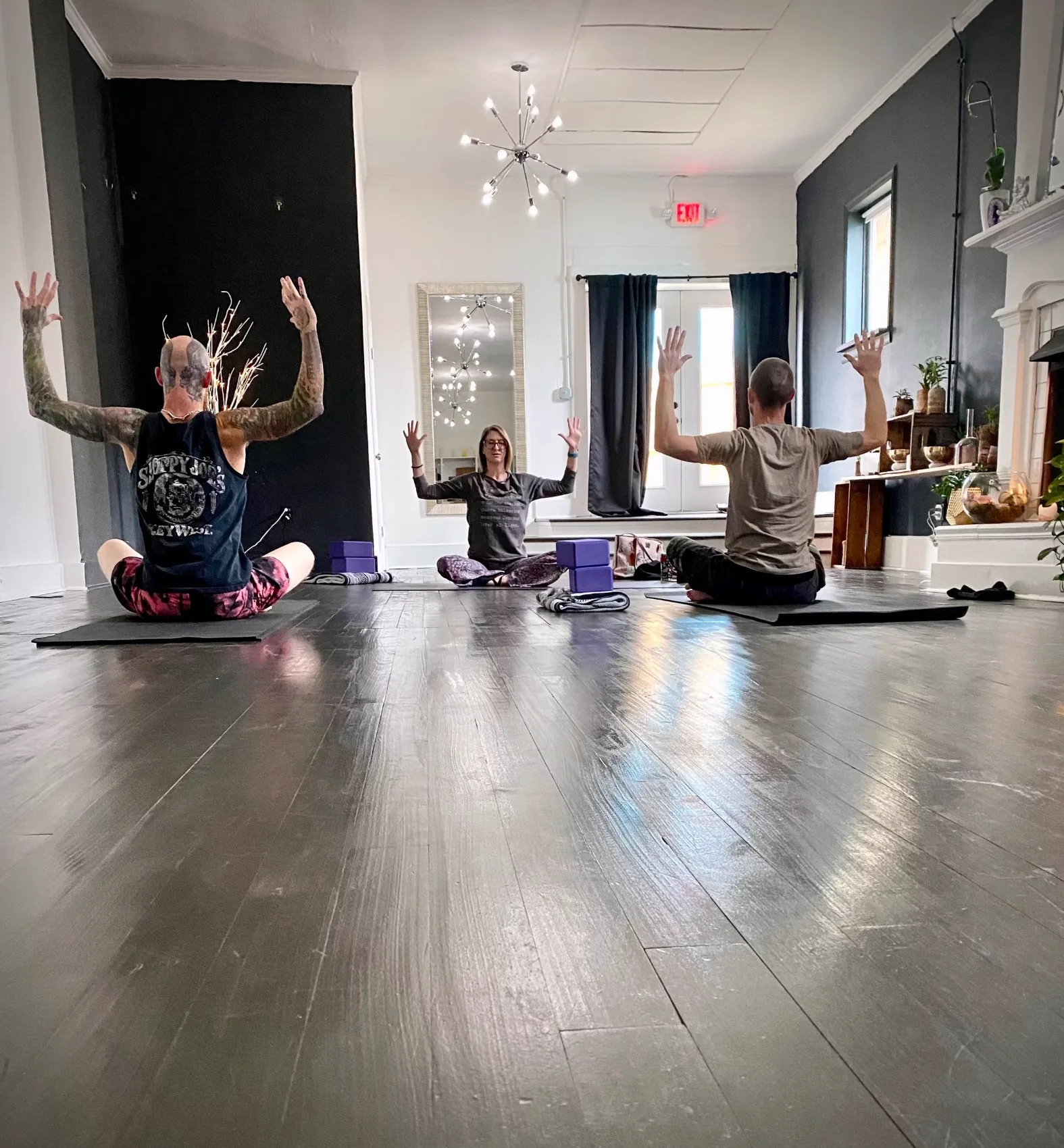 Teacher guiding seated movement and breathwork at Village Yoga